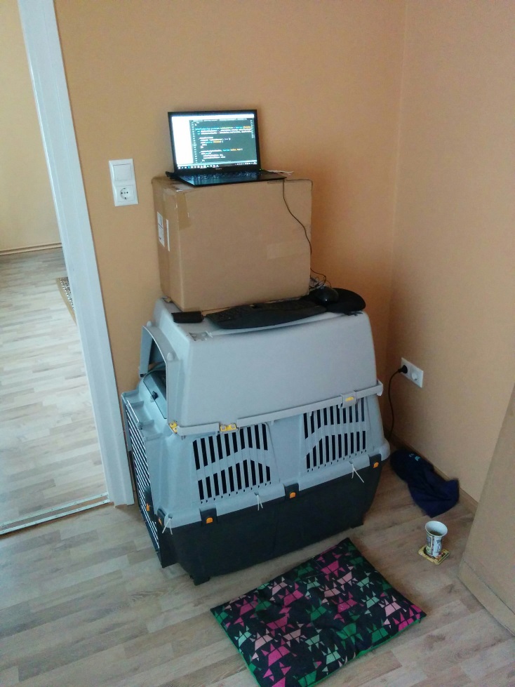 Home-made standing desk with laptop, keyboard, and mouse